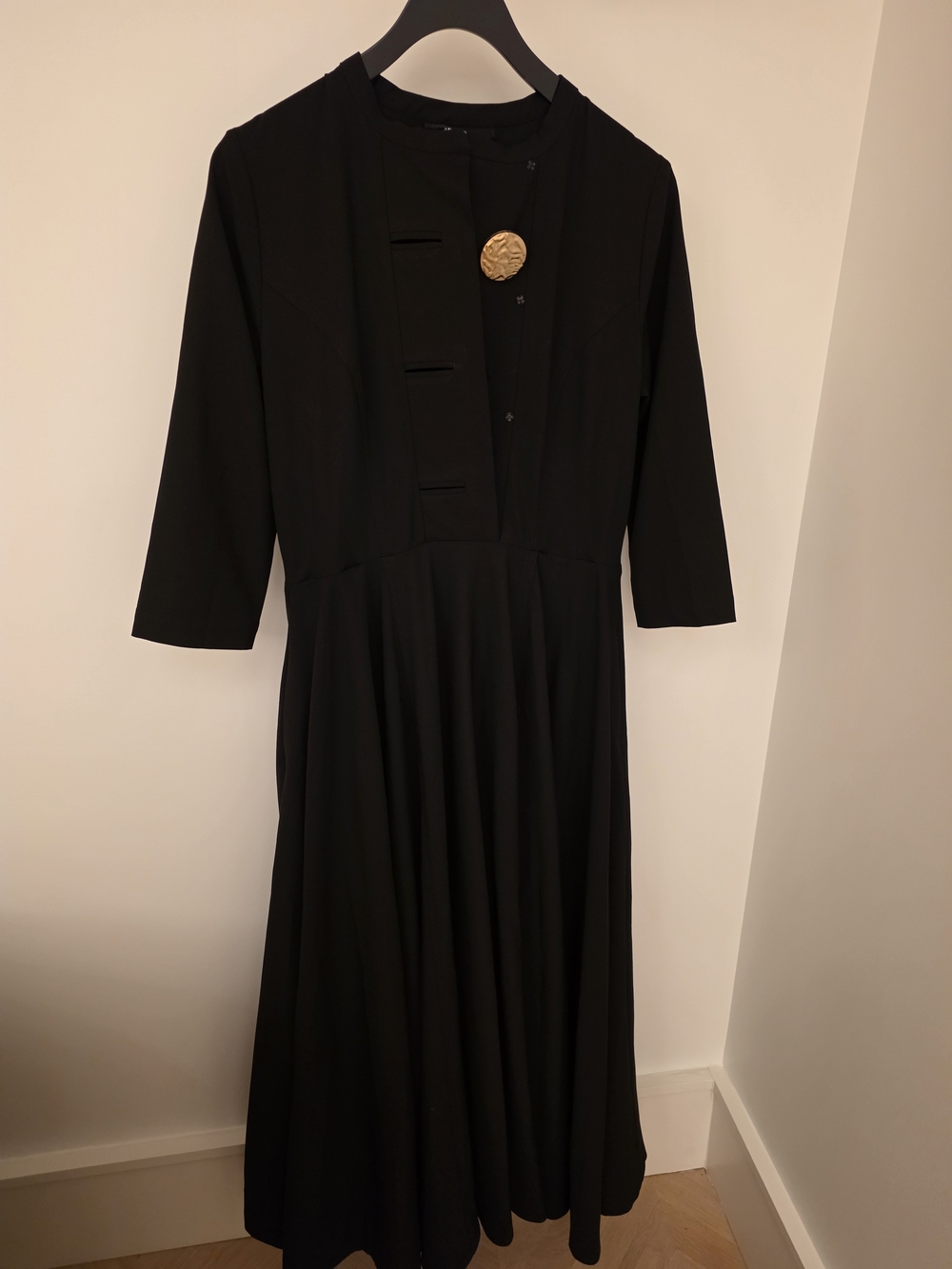 Elegant Black Dress with Signature Gold Accent